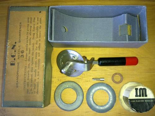 Gramophone needle sharpener, B.C.N. needle sharpener, for use with fibre or  thorn needles, red and black, in original packaging, with a packet of  needles and a spare sanding disc, 1920-1939