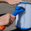 Filter cartridge cleaning comb