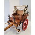 A vintage detailed miniature Ox-drawn 2 seater wagon/cart with a canopy
