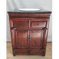 A fabulous vintage Javanese Teak double door wash stand with a black marble top and round ceramic...