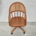 A stunning Oak bentwood mobile office chair with wicker seat and back and adjustable height and r...