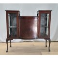 A stunning antique Mahogany bow-front cabinet with cathedral doors and marquetry inlay detailing