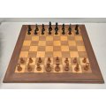 A beautifully made solid Teak wood chess board (50cm x 50cm) with a complete vintage chess set