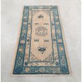 A beautiful blues and cream short-fringe pure wool vintage woven rug with oriental floral patterns