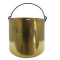 A large round brass planter pot with a forged handle
