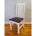 A white slatted back occasional chair with a dark wood seat