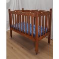 An awesome vintage solid wood drop-side baby`s cot/ crib/ bassinet with a mattress on its origina...
