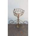 A wonderful vintage iron 4-pot plant stand and garden creeper frame