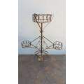 A wonderful vintage iron 4-pot plant stand and garden creeper frame