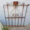 A gorgeous large antique wrought iron detailed steel garden gate