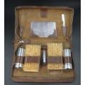 A vintage gents grooming travel kit in a leather pouch