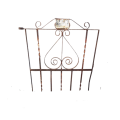 A gorgeous large antique wrought iron detailed steel garden gate