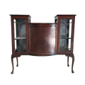 A stunning antique Mahogany bow-front cabinet with cathedral doors and marquetry inlay detailing