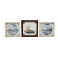 Three wonderful vintage framed Dutch themed porcelain wall tiles including two blue and white tiles
