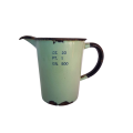 A lovely antique green enamel measuring jug in ounce, pint and grams