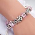 Charming Soft Pink and Silver bracelet with heart and snowflake-themed charms