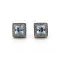 A pair of 18K gold Blue Topaz and diamond earrings.
