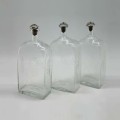 Set of three Glass Decanters with Leather Holder