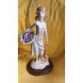 Vintage sculpture/figurine of young girl holding a fish basket