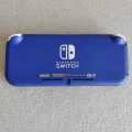 Nintendo Switch Lite console with original charger