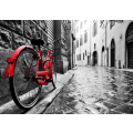 Retro vintage red bike on cobblestone street in the old town