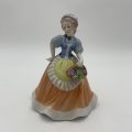 Lady With Fruit Basket Figurine