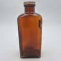 Brown Pharmaceutical Bottle with White Tin Lid