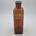 Brown Pharmaceutical Bottle with White Tin Lid