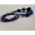 Necklace with Glass beads - Large blue round beads in the front with smaller blue beads in betwee...