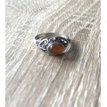 925 Silver Ring With Orange Stone On Raised Setting Surrounded By Swirls #ML700R195.00 | Dimensi...