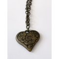 ML1600NecklaceNecklace - Rustic Metal Patterned Heart Pendant on Rustic Metal Chain250.00Rus...