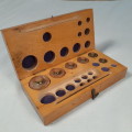 Wooden box with brass balance scale weights - incomplete