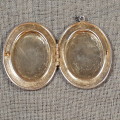 Silver metal hinged locket pendant necklace.