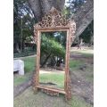 An Ornately Carved Wooden and Hand-Gilded Mirror of Large Proportion