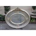 Ornate oval silver gilded mirror with crown