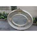 Ornate oval silver gilded mirror with crown