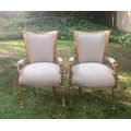 A Pair of French Style Arm Chairs, Hand-Gilded with Gold Leaf and Covered in an Imported Linen
