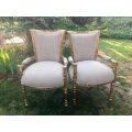 A Pair of French Style Arm Chairs, Hand-Gilded with Gold Leaf and Covered in an Imported Linen