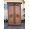 A French Provincial styled Ornately carved Armoire