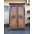A French Provincial styled Ornately carved Armoire