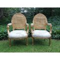 A Pair Of French Style Carved and Gilded Rattan Back Armchairs Upholstered in an Imported Fabric ...