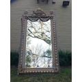 An Ornate Carved Painted Mirror