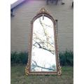 An Ornate Carved Arched Bevelled Mirror