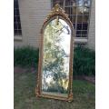 An Ornate Carved Arched Bevelled Mirror