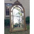 An Ornate Carved Arched Gilded Mirror