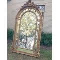 An Ornate Carved Arched Gilded Mirror