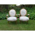 A Pair of French Style Carved and Gilded Armchairs Upholstered in a Custom-made Script on Linen F...