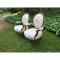 A Pair of French Style Carved and Gilded Armchairs Upholstered in a Custom-made Script on Linen F...
