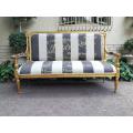 A 20th Century French Style Ornate Hand-Carved and Gilded Settee / Sofa Upholstered in a Custom-m...