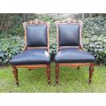 A Late 19th Century Pair of Victorian Carved Walnut Chairs Upholstered in Leather on Casters